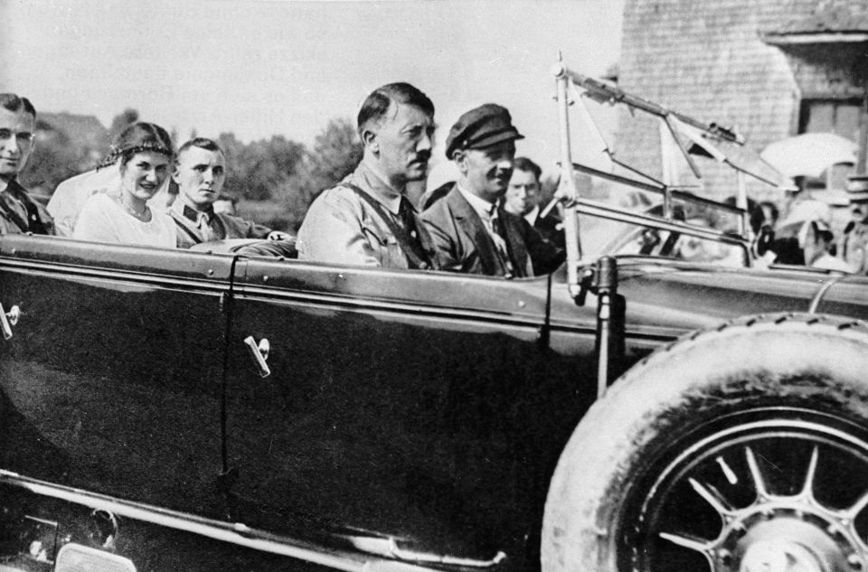 The head of the National Socialist Party of Germany, Adolf Hitler (centre), with fellow party member Martin Bormann (back) and his fiancée.