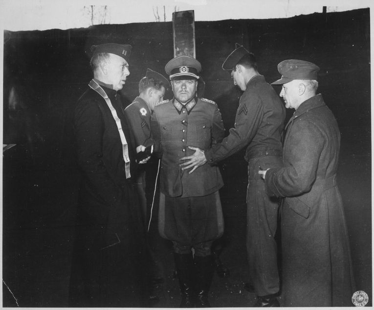 German General Anton Dostler is tied to a stake before his execution by a firing squad in the Aversa stockade. The General was convicted and sentenced to death by an American military tribunal. Aversa, Italy.