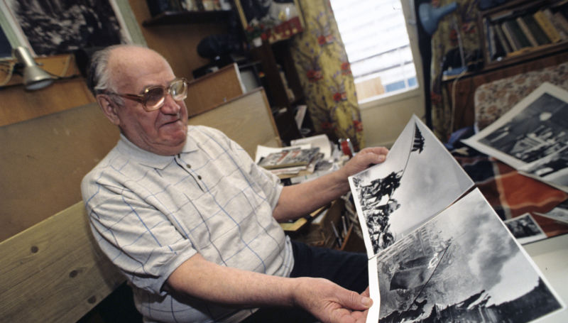 Soviet photographer Yevgeny Khaldei showing his most famous photo – Raising a Flag over the Reichstag.