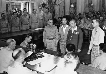 Lieutenant General Tomoyuki Yamashita, second from right, faces the military commission in a courtroom in Manilla, Philippines, on Dec. 7, 1945, as he sentenced to death by hanging by Major General Russell Reynolds, seated lower left.