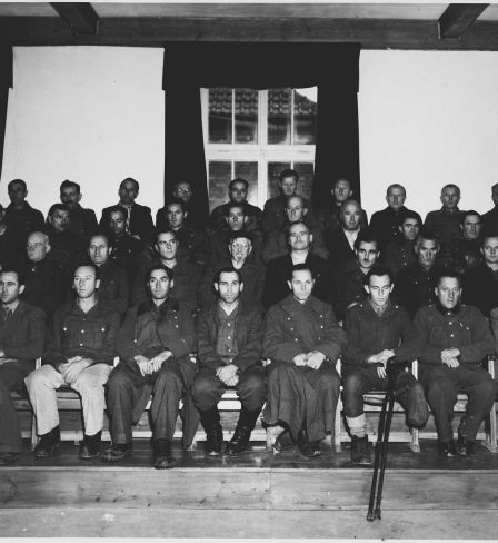Group portrait of the defendants in the Dachau war crimes trial.