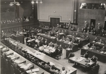 Maj. Ben Bruce Blakeney, American Associate Counsel for Defendant Shigenori Togo, addresses the court  at the International War Crimes Tribunal for the Far East, Ichigaya Court, Tokyo. 14 May 1946.