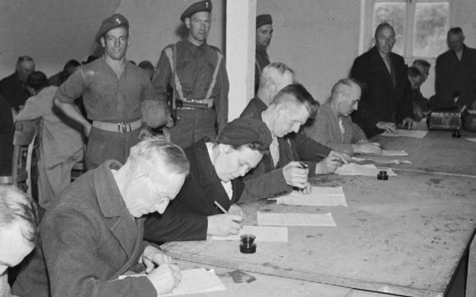 Germany Under Allied Occupation 1945 Suspected Nazis fill in a questionnaire about their political activities in a detention centre near Hamburg run by the British Army.