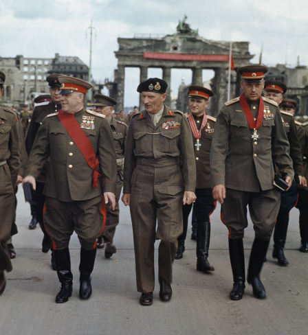 The Deputy Supreme Commander in Chief of the Red Army, Marshal G. Zhukov, the Commander of the 21st Army Group, Field Marshal Sir Bernard Montgomery, Marshal K. Rokossovsky and General Sokolovsky of the Red Army leave the Brandenburg Gate after the ceremony, 12 July 1945.
