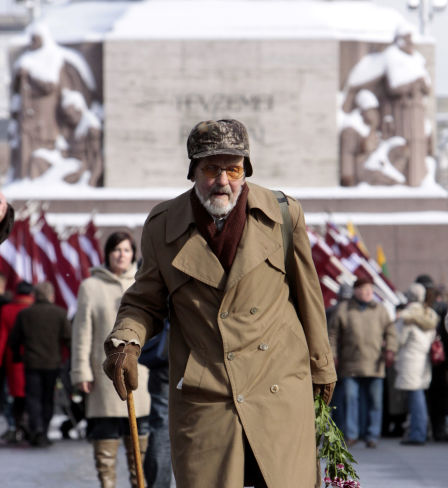 Latvian legionnaire walks to lay flowers to the Freedom Monument in Riga on the anniversary of the foundation of the Latvian Legion, a formation of the German Waffen-SS.