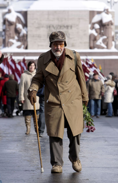 Latvian legionnaire walks to lay flowers to the Freedom Monument in Riga on the anniversary of the foundation of the Latvian Legion, a formation of the German Waffen-SS.