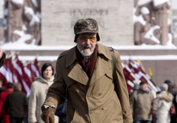 Latvian legionnaire walks to lay flowers to the Freedom Monument in Riga on the anniversary of the foundation of the Latvian Legion, a formation of the German Waffen-SS.