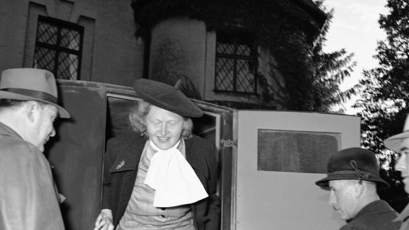 Ilse Koch, infamous mistress of Buchenwald, leaves police car prior to entering Aichach women’s prison at Augsburg, Germany  Oct. 17, 1949. She was released earlier from an American prison at Landsberg, Germany, after completing a four-year prison sentence on charges growing out of a reign of sadism at the Buchenwald concentration camp. She will now be tried by her own countrymen on similar charges. She was originally sentenced to the imprisonment, but this was reduced to four years. Man at left unidentified.