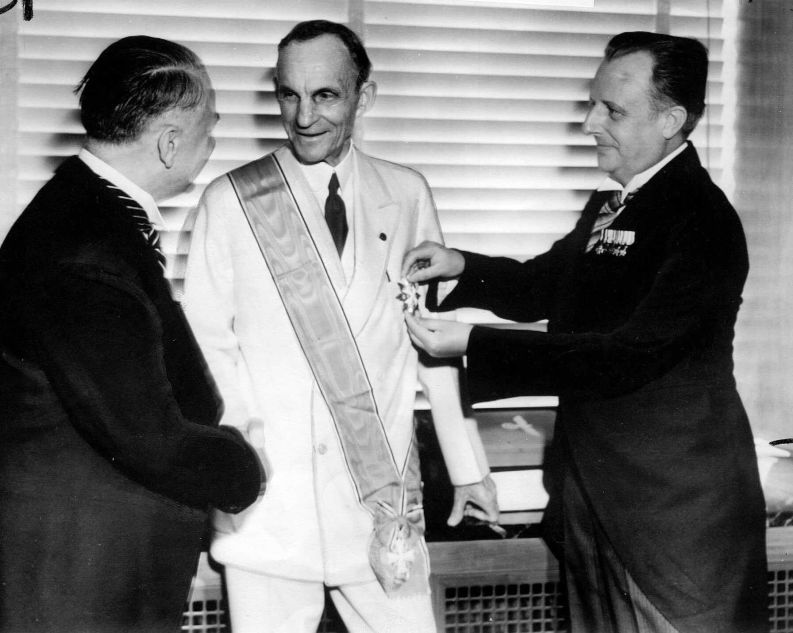 German diplomats award Henry Ford, center, Nazi Germany's highest decoration for foreigners, The Grand Cross of the German Eagle, in Detroit on July, 30, 1938 for his  service  to the Third Reich.  Karl Kapp, German consul in Cleveland pins the medal while Fritz Heiler, left, German consul in Detroit shakes his hand. General Motors Corp. and Ford Motor Co. deny helping the Nazis during World War II and profiting from forced labor at their German subsidiaries.  (AP Photo)