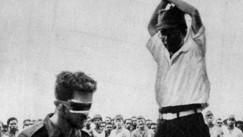 An undated snapshot found on the body of a dead Japanese soldier shows the execution, by a Japanese officer armed with a Samurai sword, of a blindfolded Allied prisoner of war, believed to be a member of the Australian Air Force, during the Second World War. The execution, in breach of the laws of protection granted to men taken in war, is watched by a crowd of Japanese troops