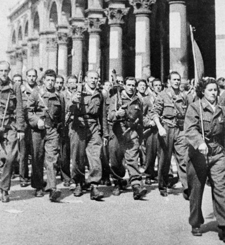 Italian Resistance troops march through the streets of Milan.