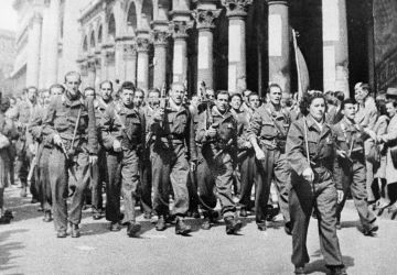 Italian Resistance troops march through the streets of Milan.