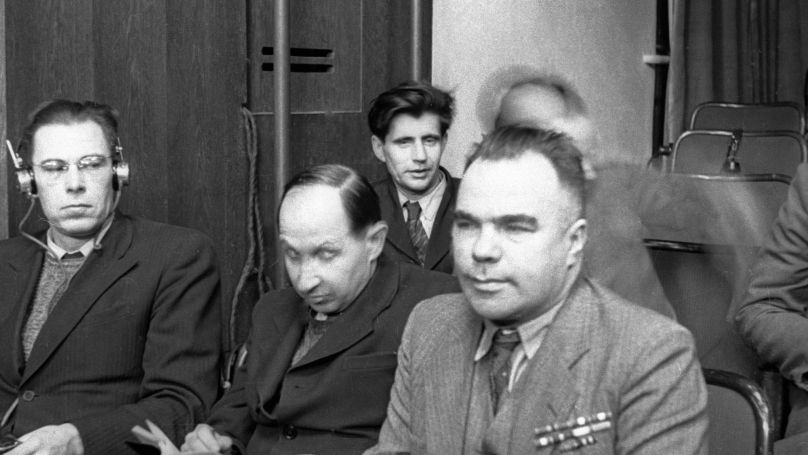 Playwright, author and journalist Vsevolod Vishnevsky (right) and Kukryniksy during a Nuremberg Trial session.