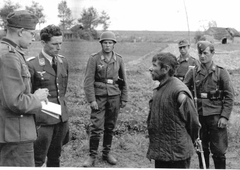 The Nazis interrogate a Soviet partisan. Summer 1942. Demyansky, Kholmsky district, Novgorod Region.