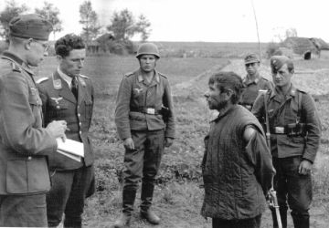 The Nazis interrogate a Soviet partisan. Summer 1942. Demyansky, Kholmsky district, Novgorod Region.